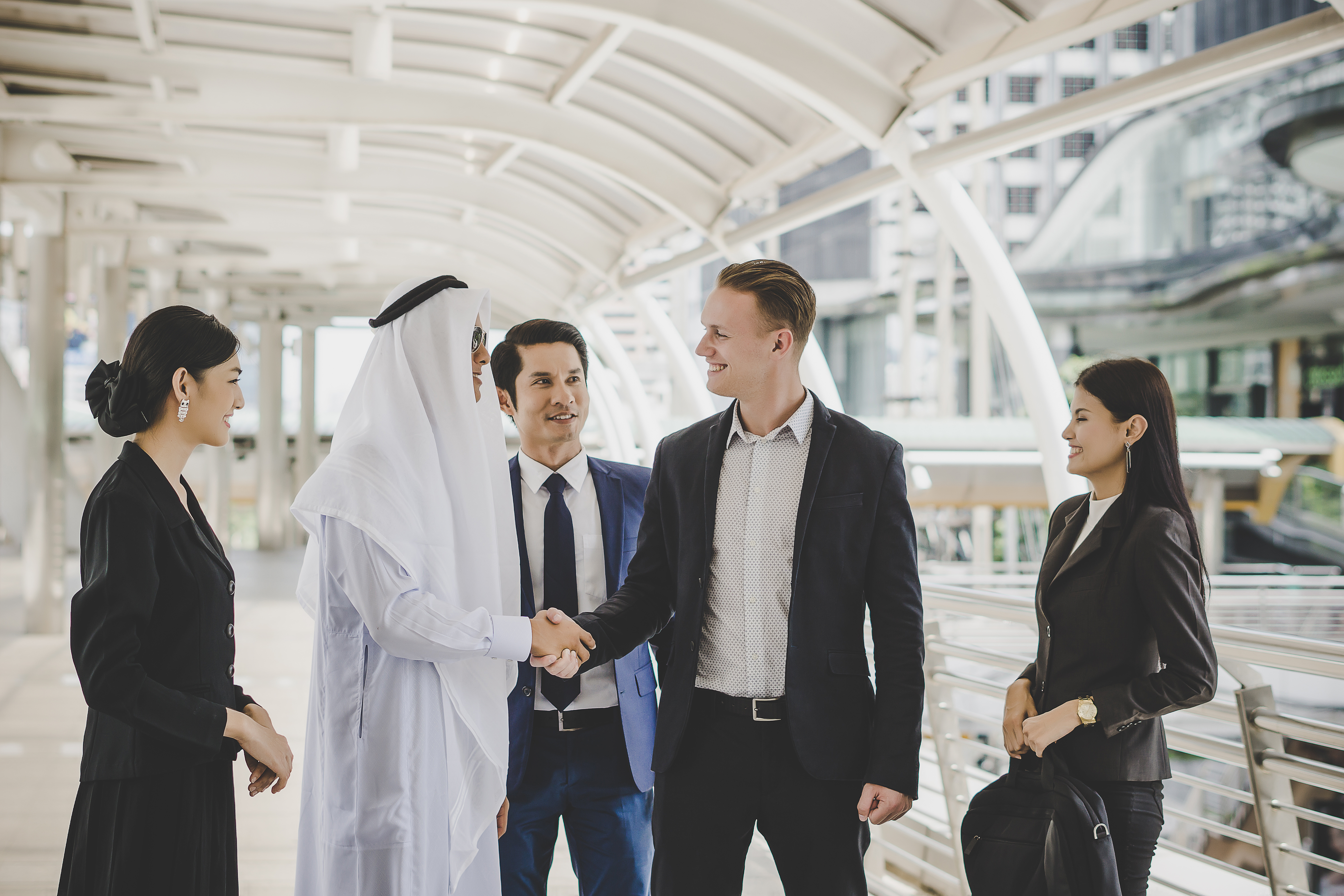 Arab and international business professionals shaking hands